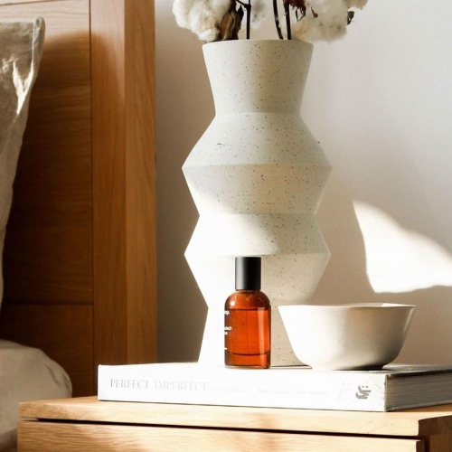 Beautiful bedrooms to fit every need a vase with cotton stems on a bedside table