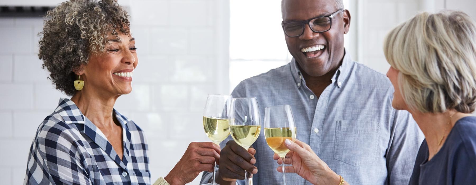 a few people toasting wine glasses